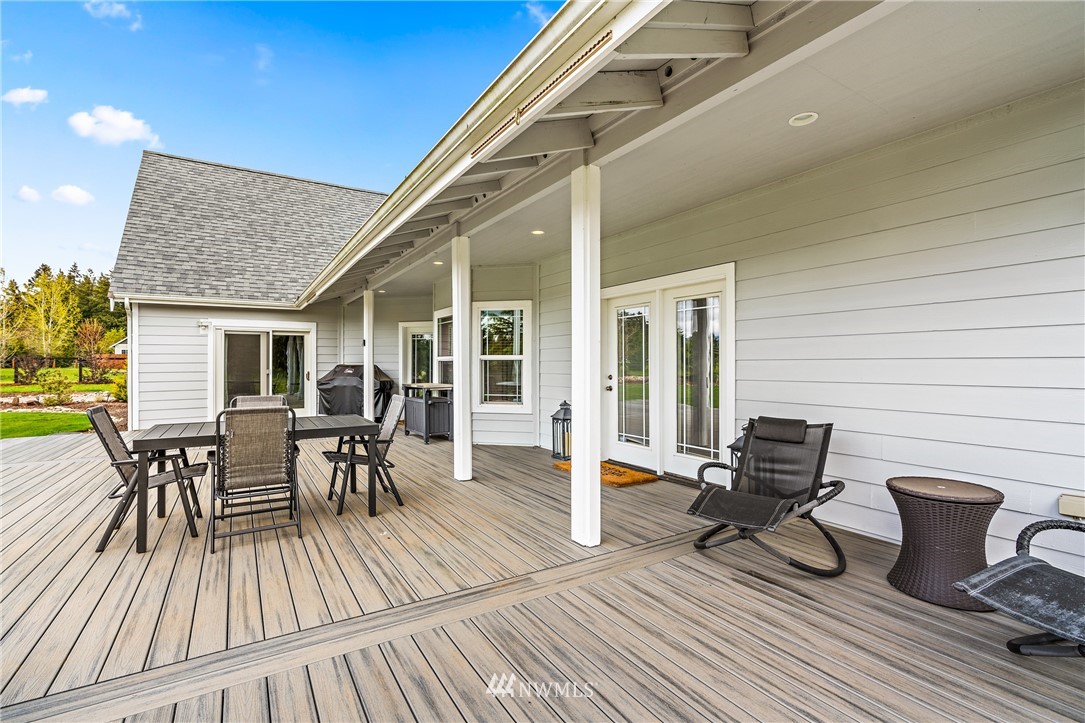 13323 Erskine Road Southwest Rochester, WA 98579 - Photo 25 of 30 a view of a roof deck with table and chairs and wooden floor