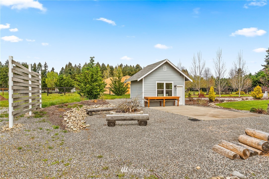 13323 Erskine Road Southwest Rochester, WA 98579 - Photo 26 of 30 a front view of a house with a yard and trees
