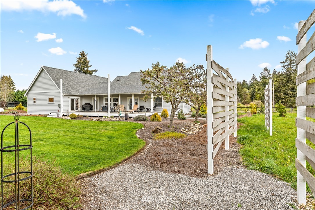 13323 Erskine Road Southwest Rochester, WA 98579 - Photo 27 of 30 a view of a house with a yard patio and swimming pool