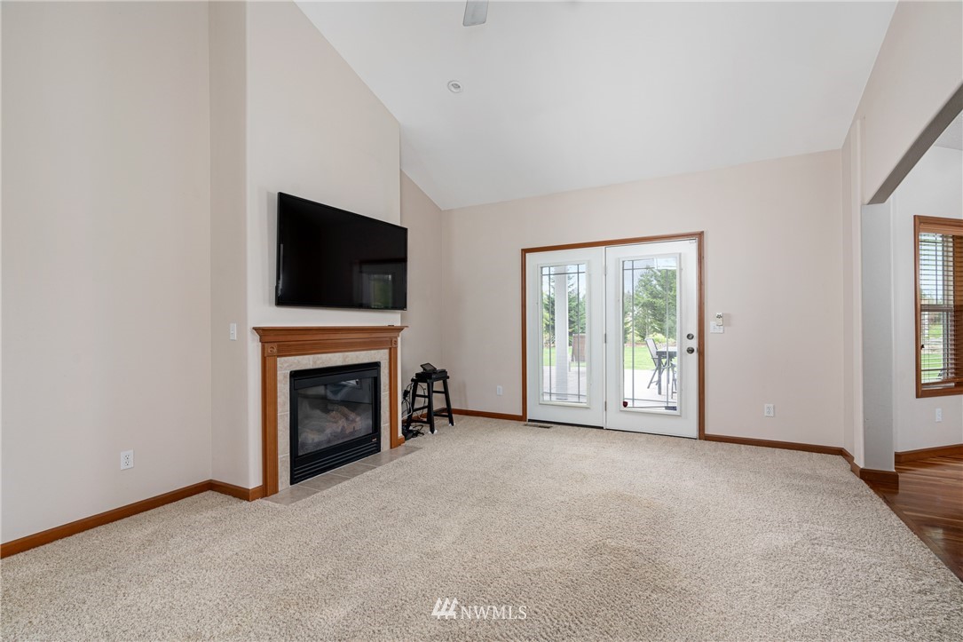 13323 Erskine Road Southwest Rochester, WA 98579 - Photo 7 of 30 a view of an empty room with a window and fireplace