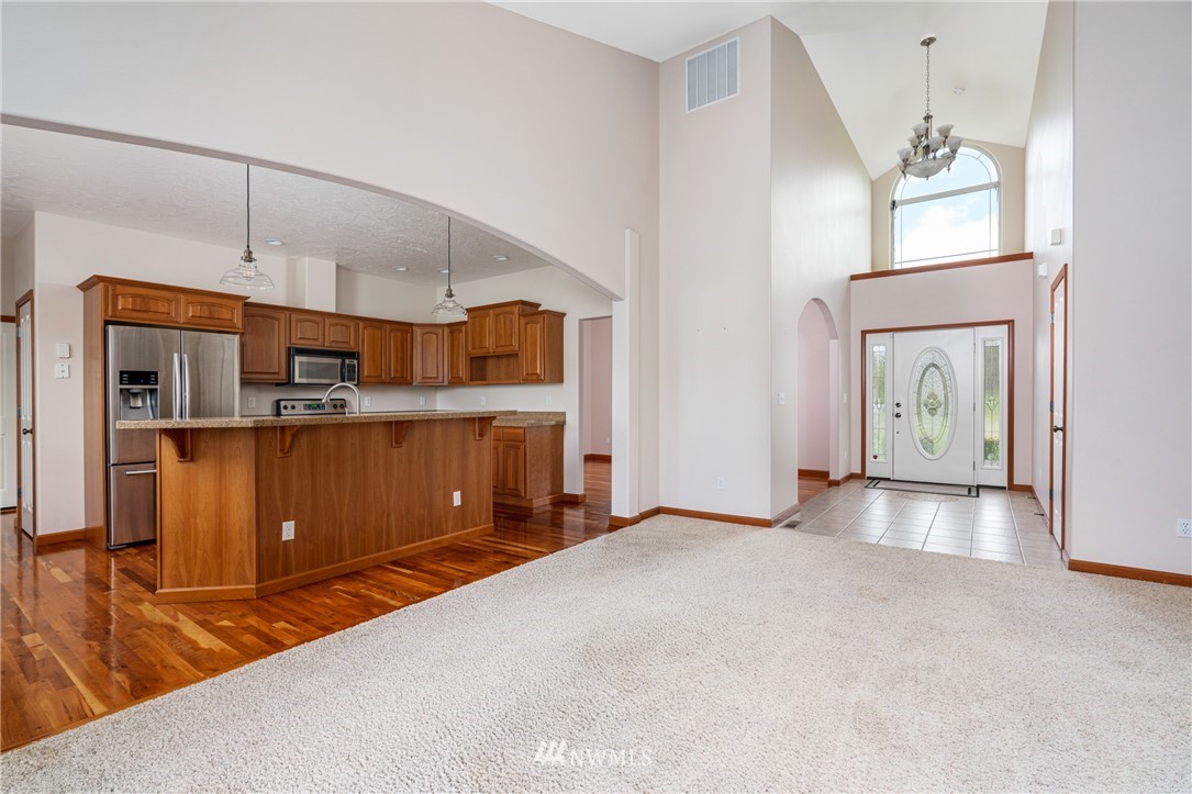 13323 Erskine Road Southwest Rochester, WA 98579 - Photo 8 of 30 a view of a kitchen with furniture and wooden floor