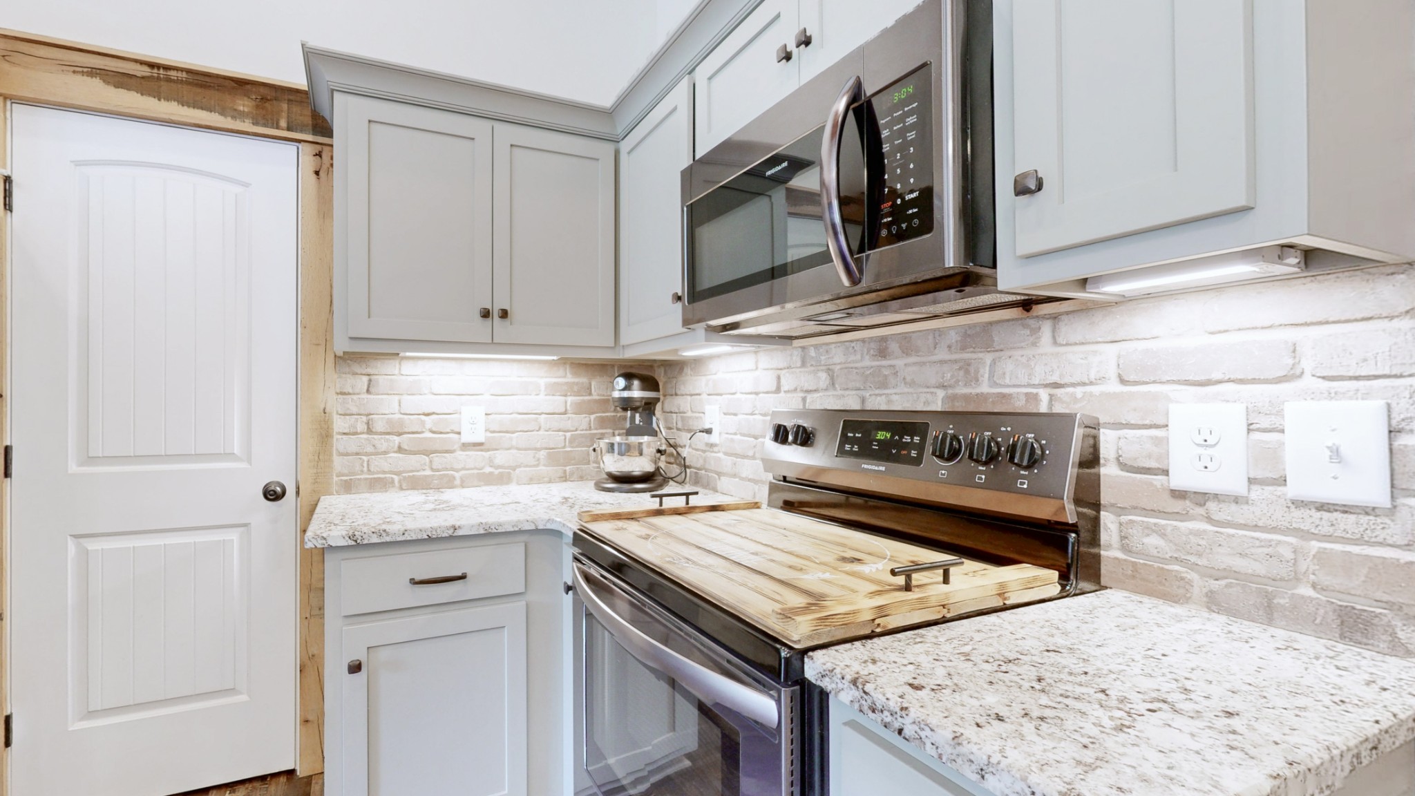 601 King Ridge Road Dowelltown, TN 37059 - Photo 19 of 49 a kitchen with stainless steel appliances granite countertop a stove a sink and a microwave