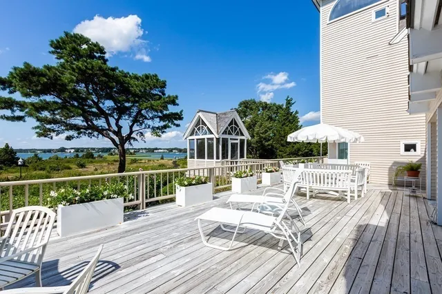 a view of balcony with wooden floor and outdoor seating