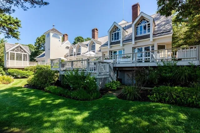 a front view of a house with a garden and plants