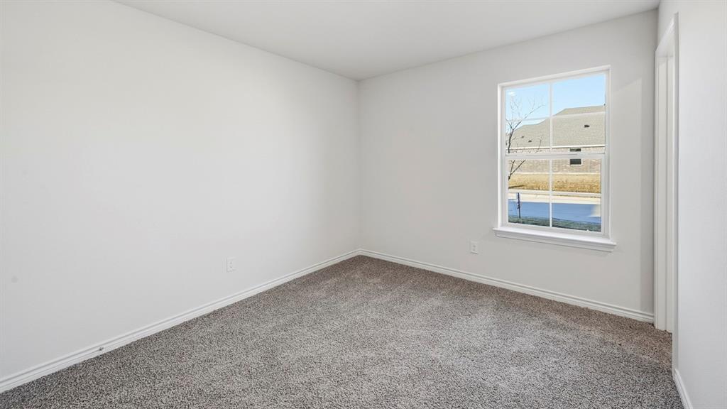 419 Epiphany Lane Lavon, TX 75166 - Photo 23 of 31 Room with neutral carpet flooring and white baseboards