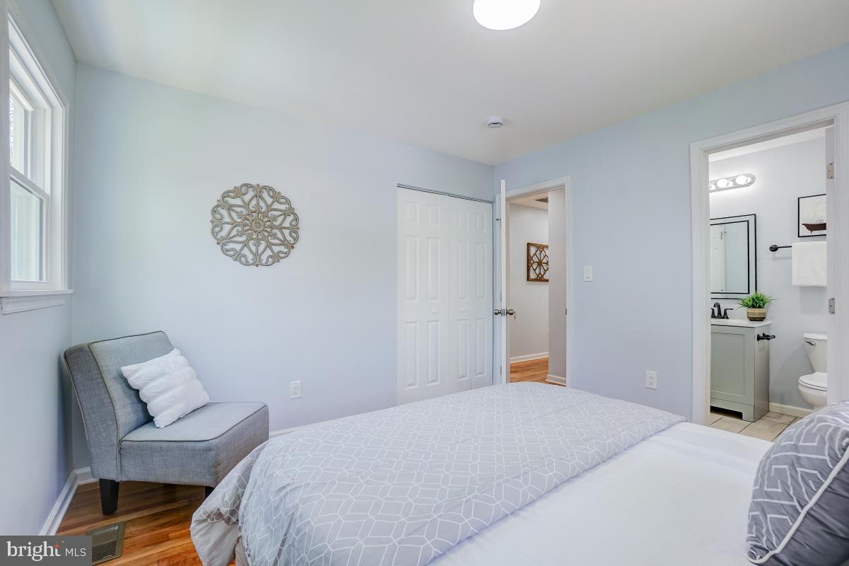 2654 Cory Terrace Silver Spring, MD 20902 - Photo 13 of 32 a bedroom with a bed and a chandelier