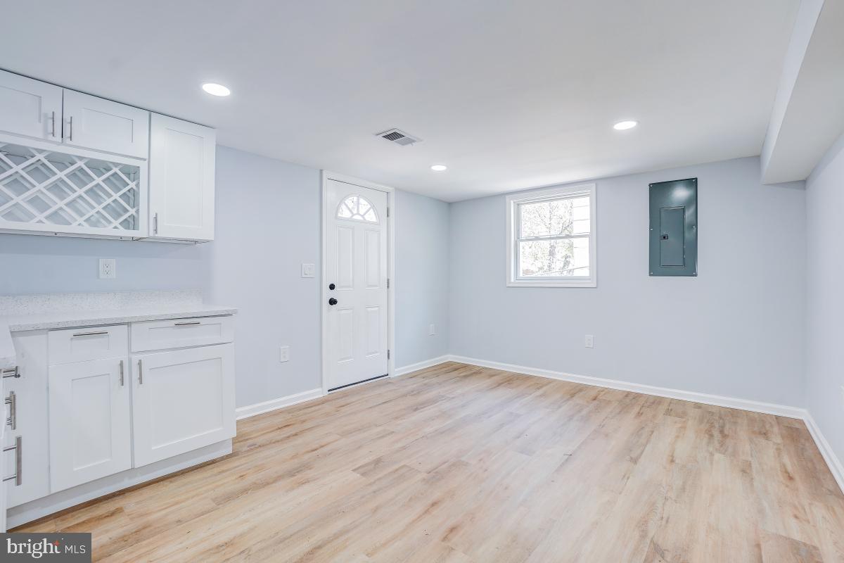 2654 Cory Terrace Silver Spring, MD 20902 - Photo 23 of 32 a view of an empty room with a window and wooden floor