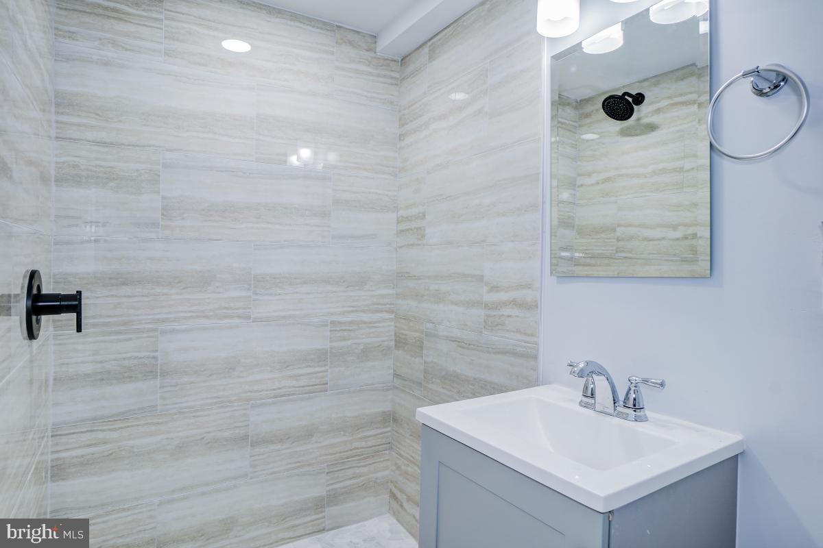 2654 Cory Terrace Silver Spring, MD 20902 - Photo 28 of 32 a bathroom with a sink mirror and shower