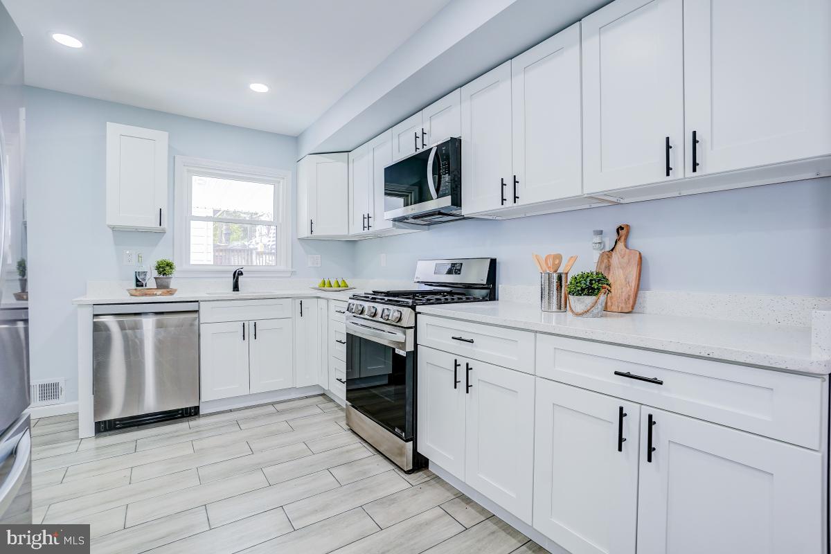 2654 Cory Terrace Silver Spring, MD 20902 - Photo 7 of 32 a kitchen with cabinets stainless steel appliances and a window