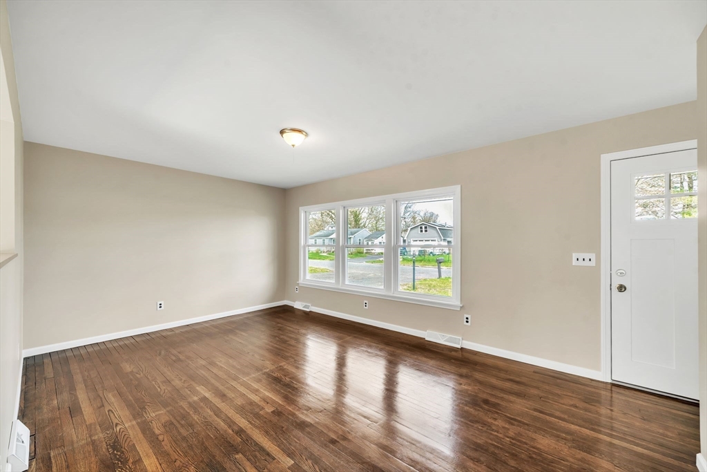 230 Gilbert Avenue Springfield, MA 01119 - Photo 13 of 40 an empty room with wooden floor and windows