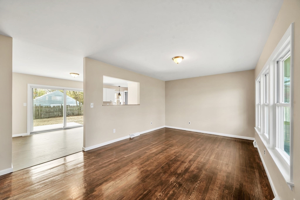 230 Gilbert Avenue Springfield, MA 01119 - Photo 14 of 40 an empty room with wooden floor and windows