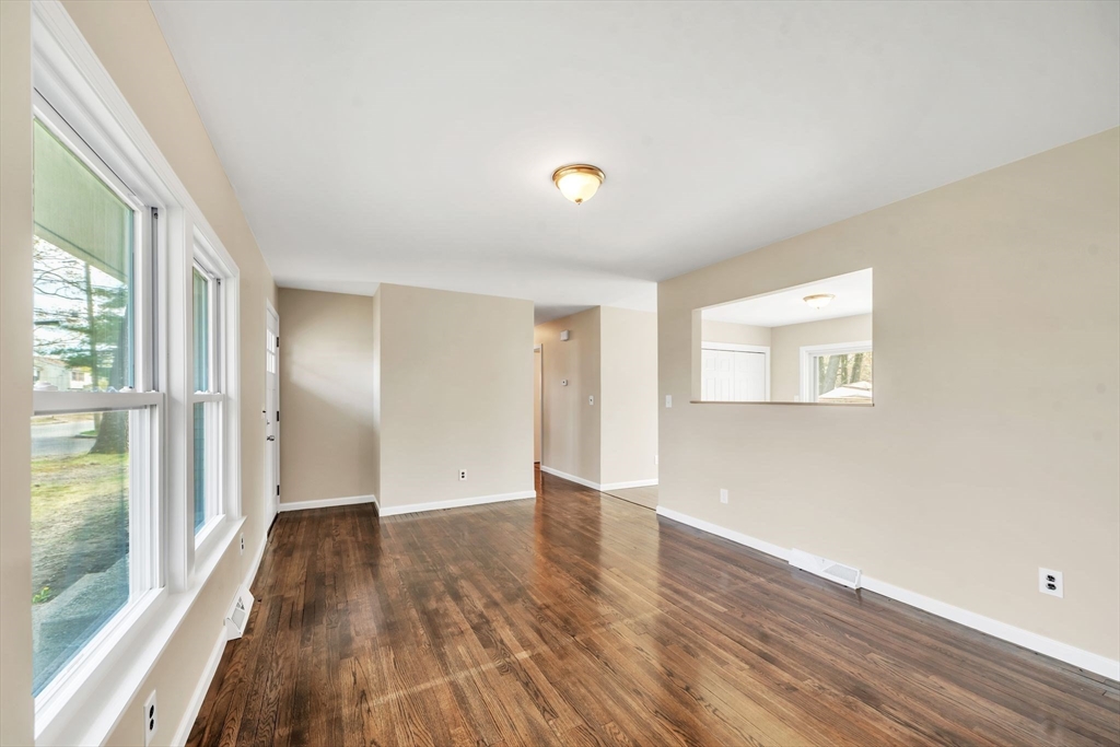 230 Gilbert Avenue Springfield, MA 01119 - Photo 15 of 40 a view of an empty room with wooden floor and a window