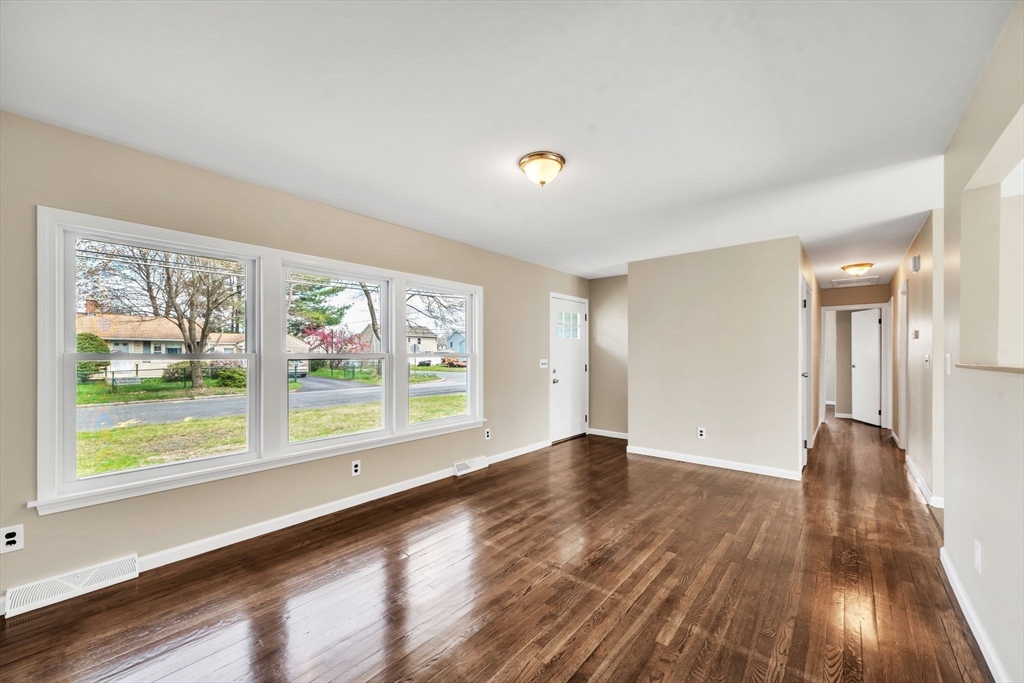 230 Gilbert Avenue Springfield, MA 01119 - Photo 16 of 40 a view of an empty room with wooden floor and a window