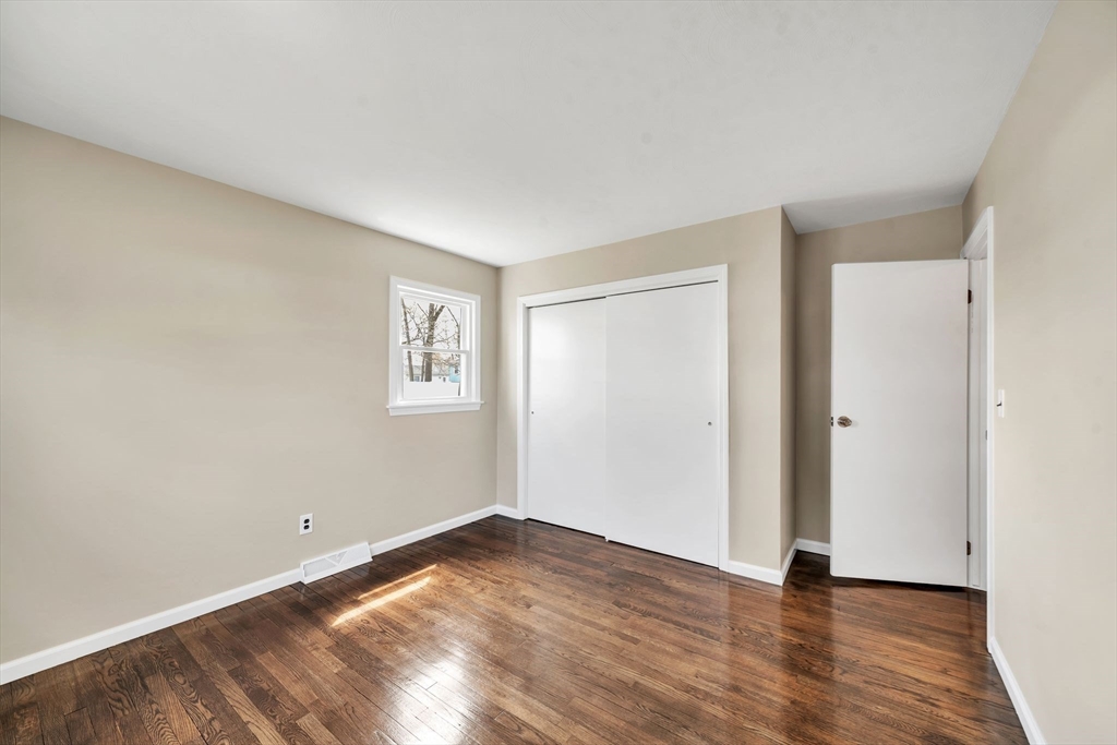 230 Gilbert Avenue Springfield, MA 01119 - Photo 17 of 40 a view of an empty room with wooden floor and a window