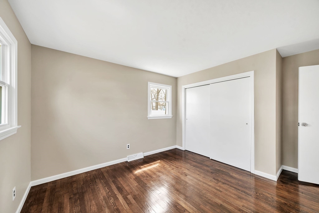 230 Gilbert Avenue Springfield, MA 01119 - Photo 18 of 40 an empty room with wooden floor and windows