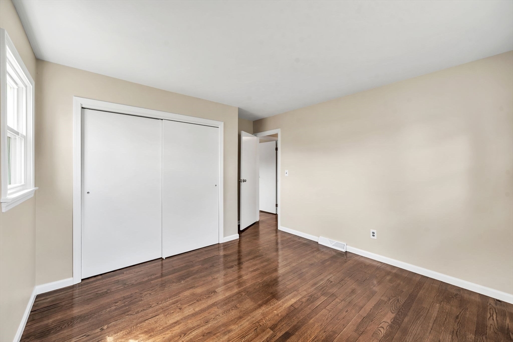 230 Gilbert Avenue Springfield, MA 01119 - Photo 19 of 40 a view of an empty room with wooden floor and a window