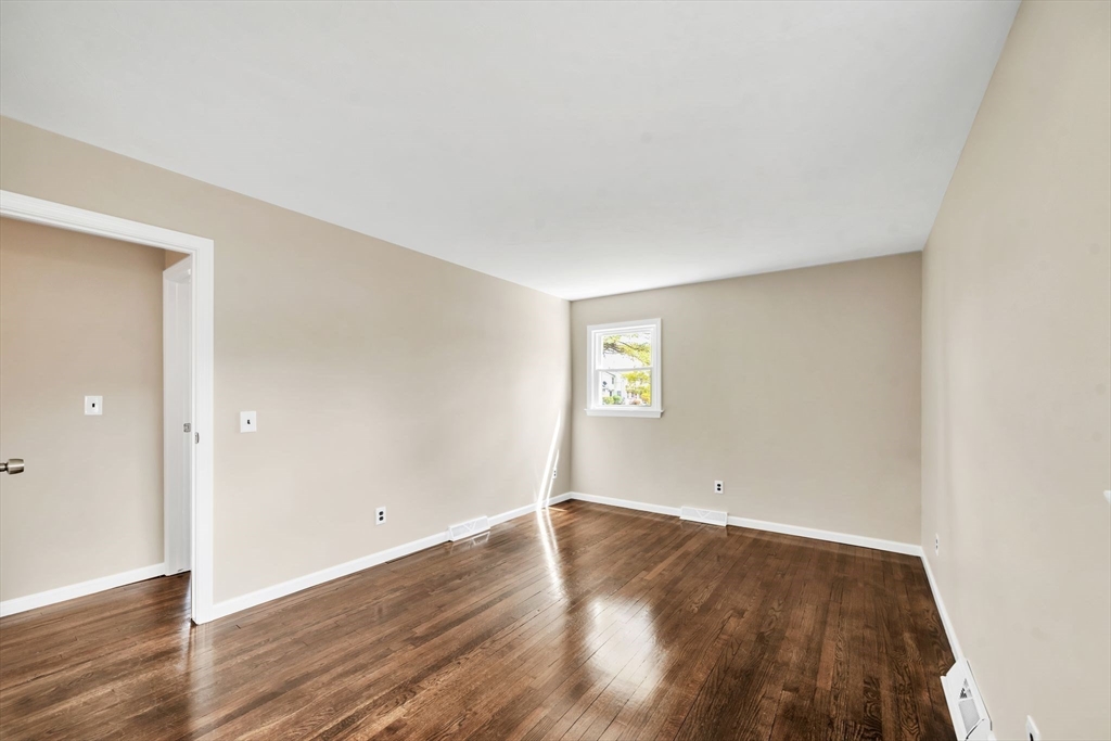 230 Gilbert Avenue Springfield, MA 01119 - Photo 20 of 40 an empty room with wooden floor and windows