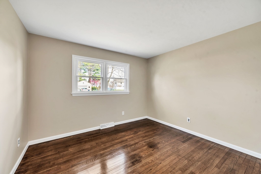 230 Gilbert Avenue Springfield, MA 01119 - Photo 23 of 40 an empty room with wooden floor and window
