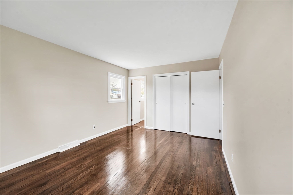 230 Gilbert Avenue Springfield, MA 01119 - Photo 30 of 40 a view of an empty room with wooden floor and a window
