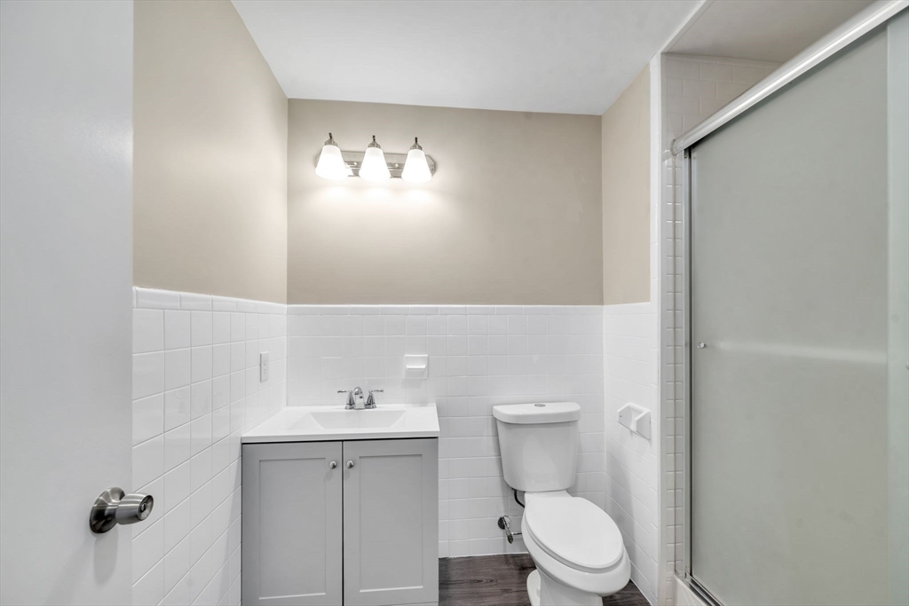 230 Gilbert Avenue Springfield, MA 01119 - Photo 32 of 40 a bathroom with a toilet a sink and mirror