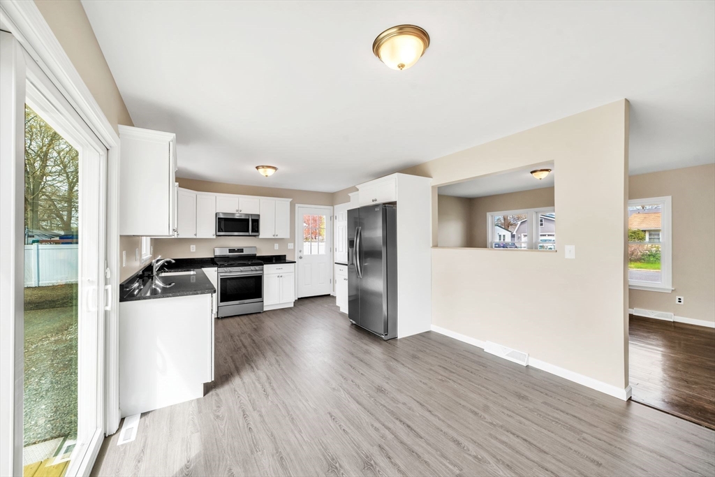 230 Gilbert Avenue Springfield, MA 01119 - Photo 6 of 40 a kitchen with a refrigerator a stove top oven a sink and a potted plant