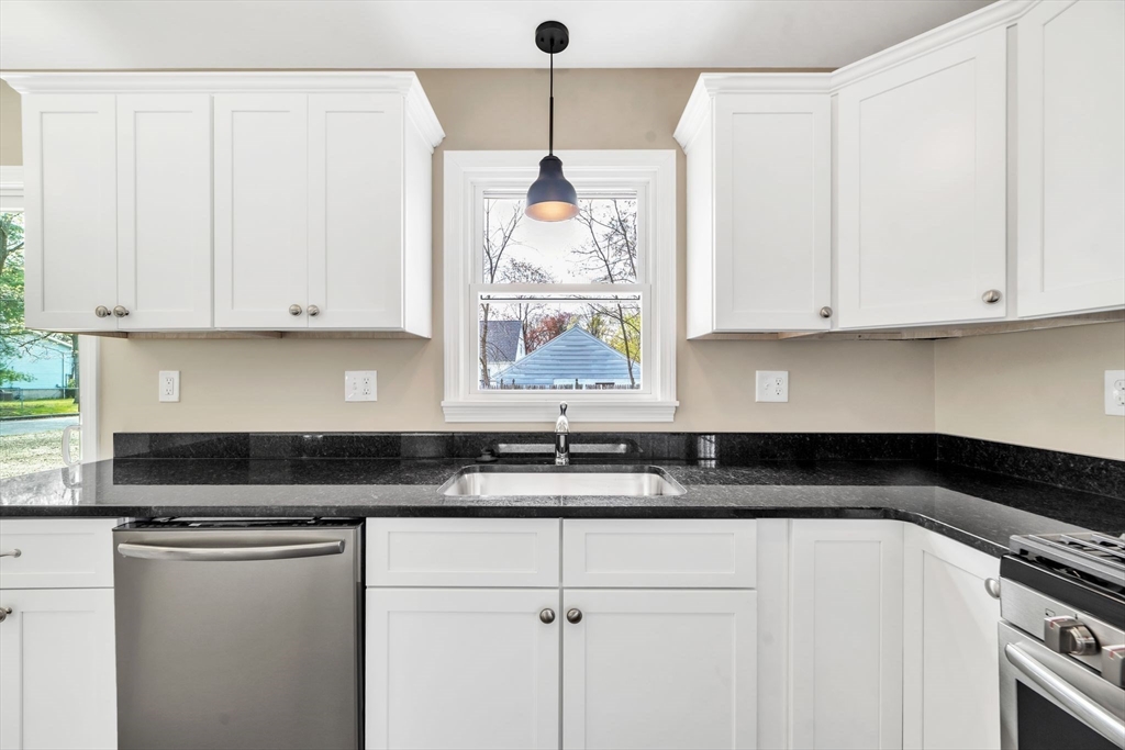 230 Gilbert Avenue Springfield, MA 01119 - Photo 8 of 40 a kitchen with granite countertop white cabinets and sink