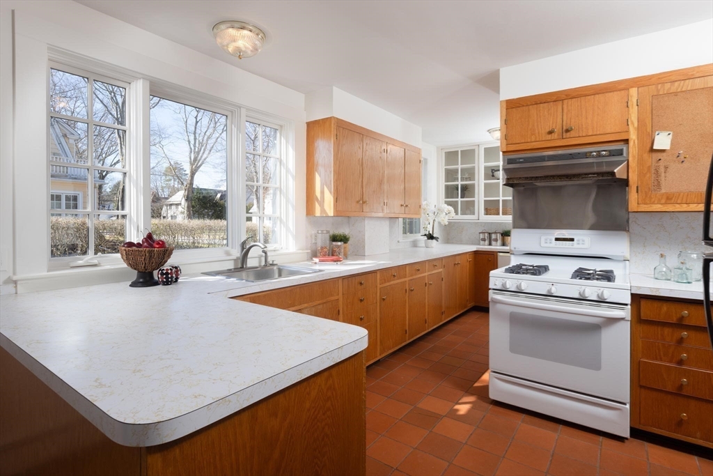 10 Locke Road Newton, MA 02468 - Photo 11 of 16 a kitchen with a stove a sink and a refrigerator