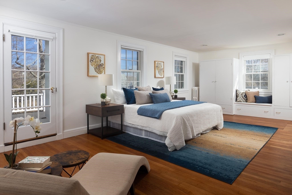 10 Locke Road Newton, MA 02468 - Photo 12 of 16 a bedroom with a bed and wooden floor