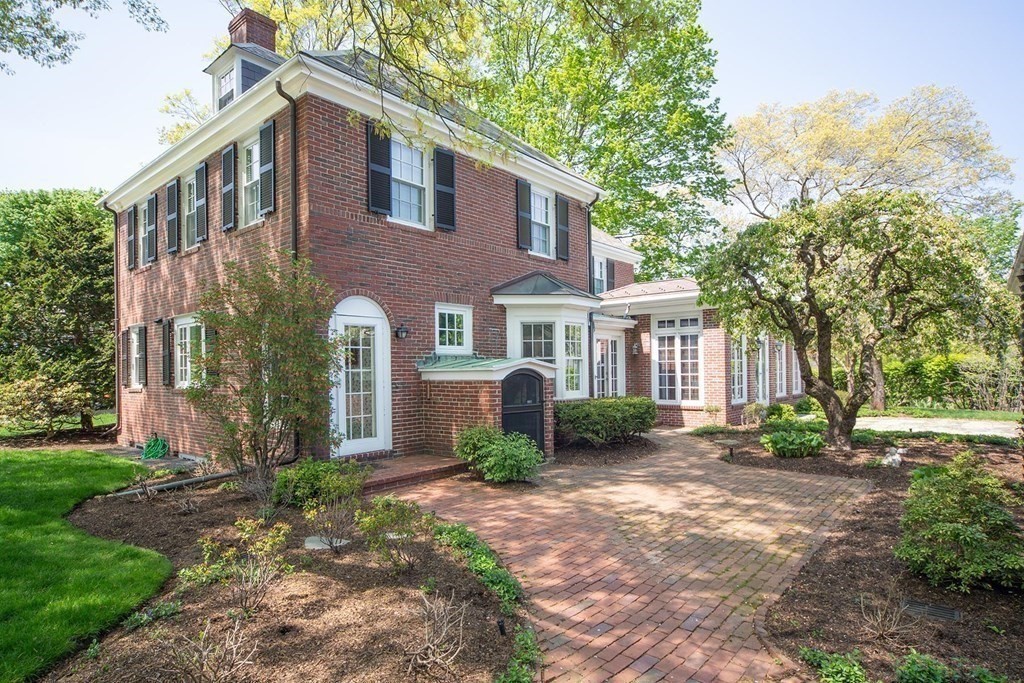 10 Locke Road Newton, MA 02468 - Photo 15 of 16 a view of a brick house with many windows plants and large tree