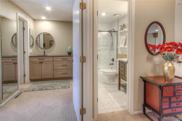 a bathroom with a sink a toilet and a mirror