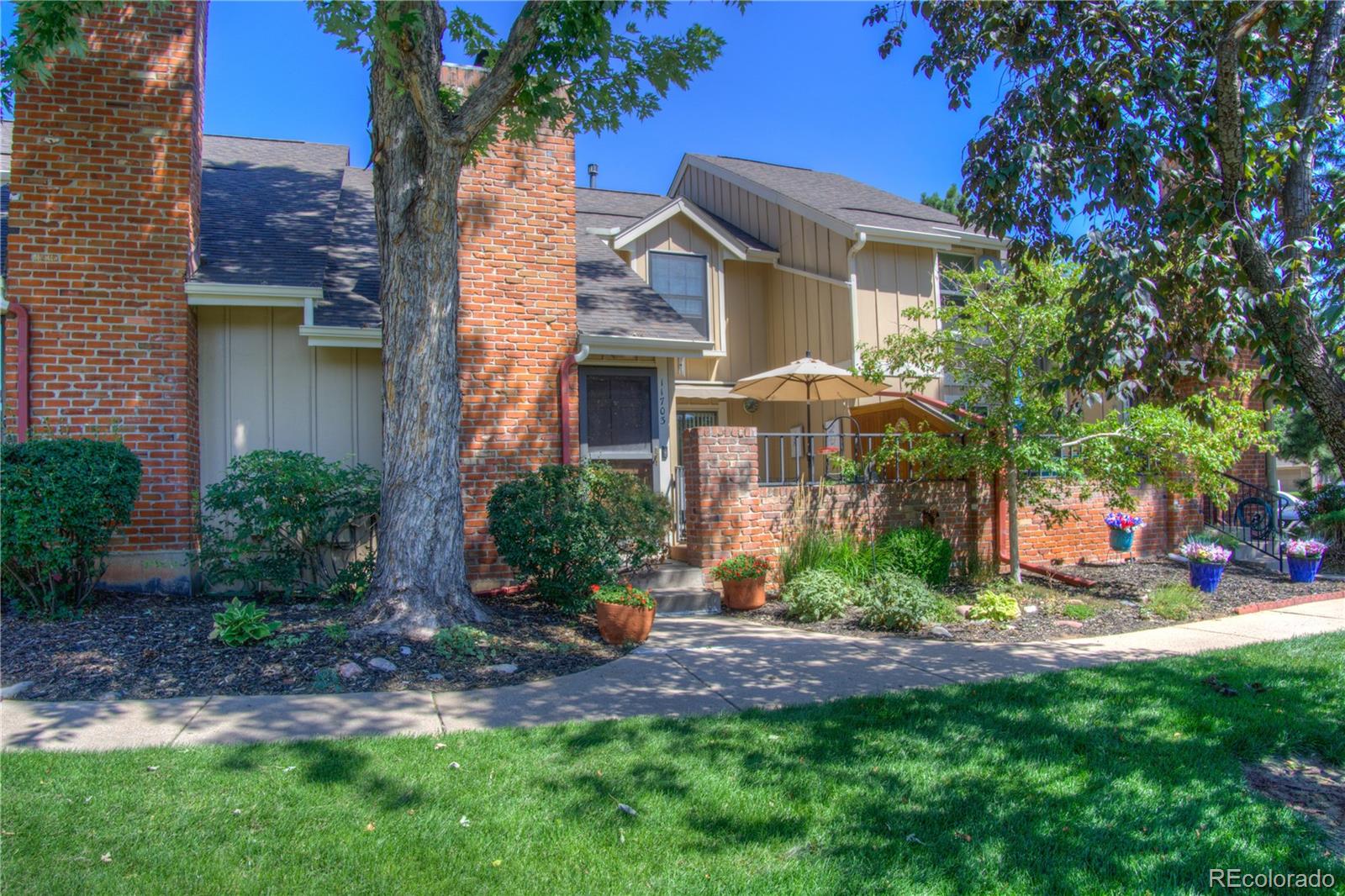 11703 West Elk Head Range Road Littleton, CO 80127 - Photo 2 of 46 a front view of a house with garden