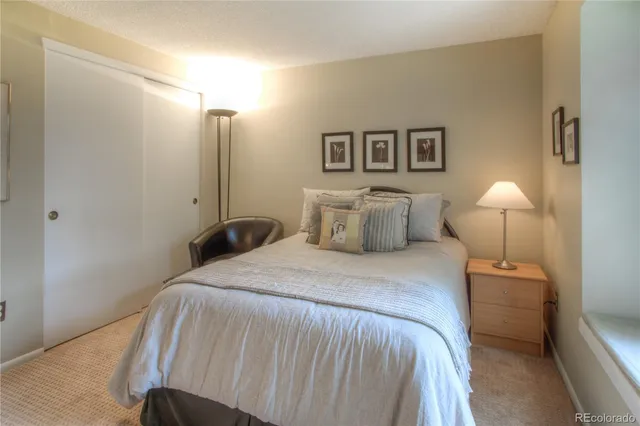 a bedroom with a bed and a lamp