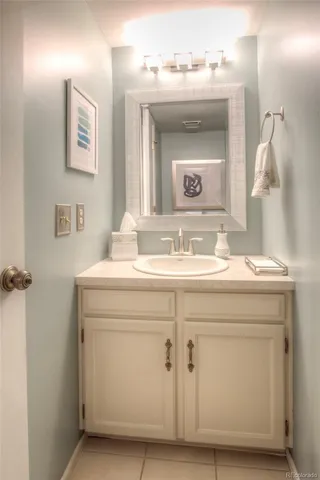 a bathroom with a sink vanity and a mirror