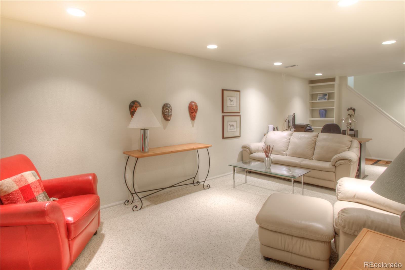 11703 West Elk Head Range Road Littleton, CO 80127 - Photo 28 of 46 a living room with furniture and a ceiling fan