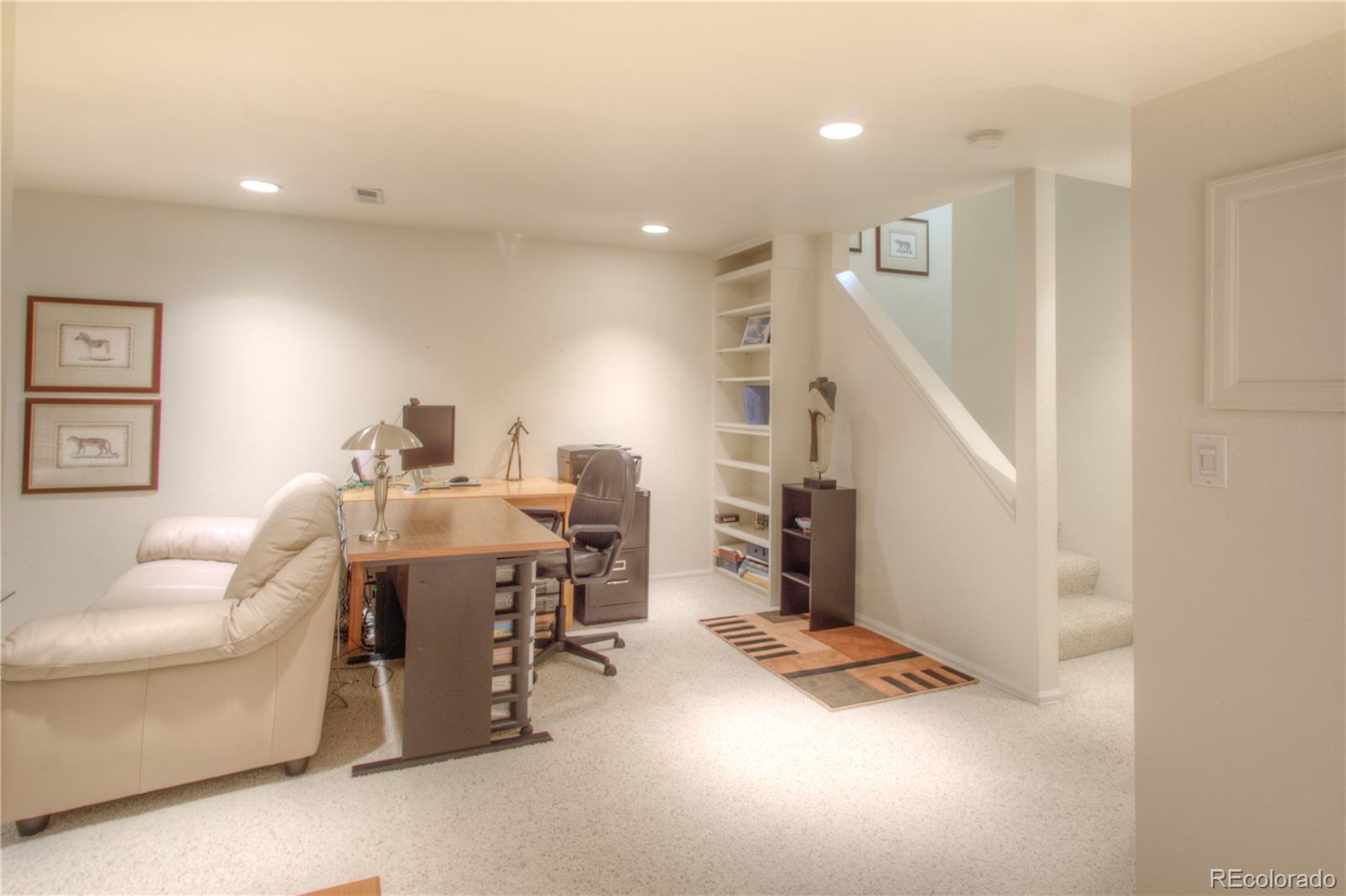 11703 West Elk Head Range Road Littleton, CO 80127 - Photo 29 of 46 a living room with furniture and wooden floor