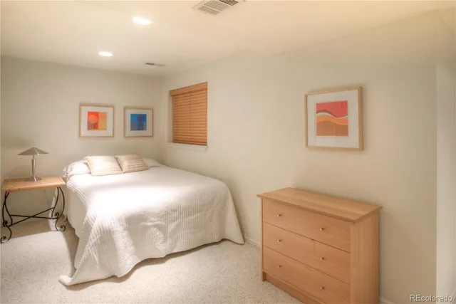 a bedroom with a bed and a dresser