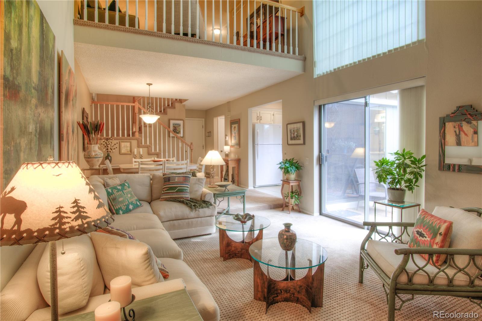11703 West Elk Head Range Road Littleton, CO 80127 - Photo 3 of 46 a living room with furniture and a chandelier