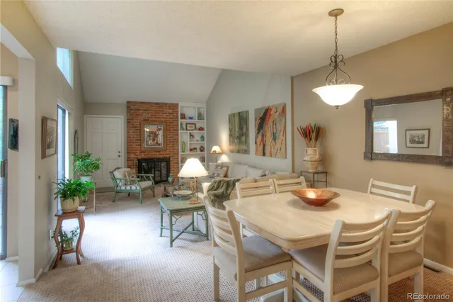 a dining room with furniture a chandelier and wooden floor