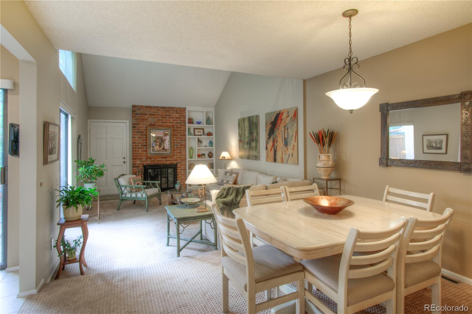 11703 West Elk Head Range Road Littleton, CO 80127 - Photo 4 of 46 a dining room with furniture a chandelier and wooden floor