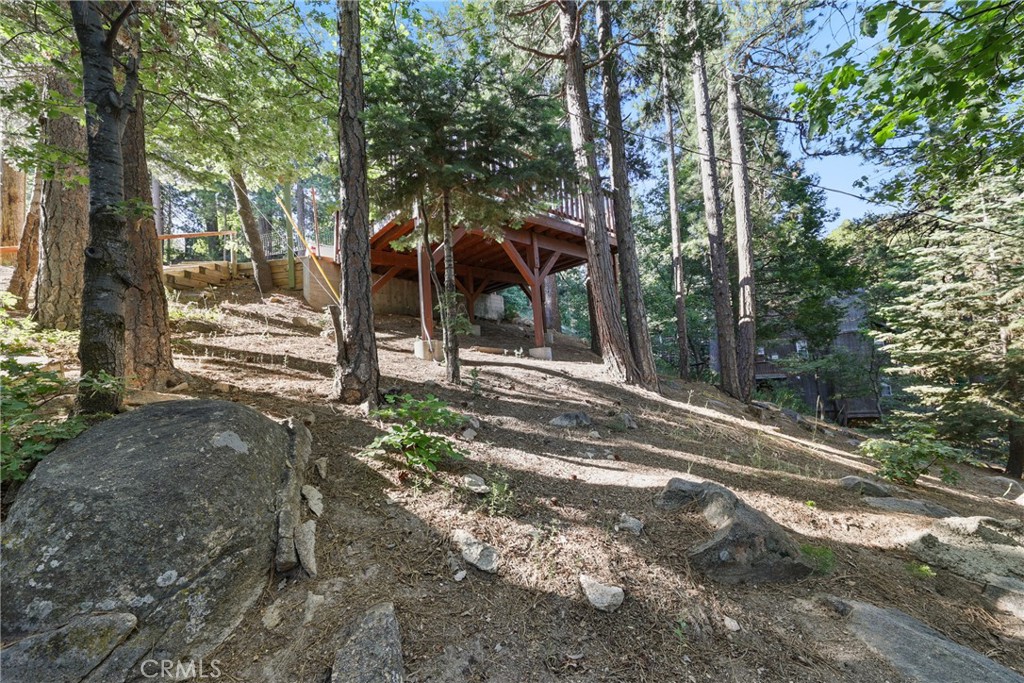 8 Lake Forest Drive Twin Peaks, CA 92391 - Photo 7 of 7 a view of a park that has large trees and a wooden fence