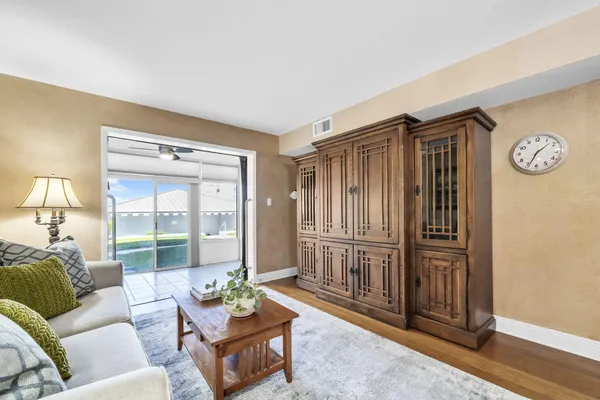 a living room with furniture and wooden floor