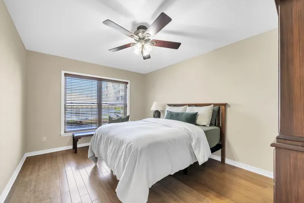 a bedroom with a bed and a chandelier