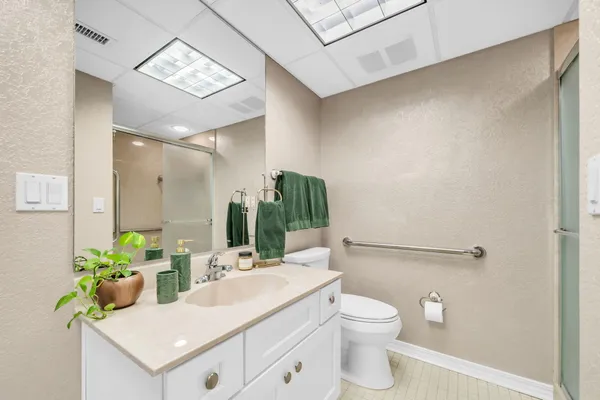 a bathroom with a glass shower door