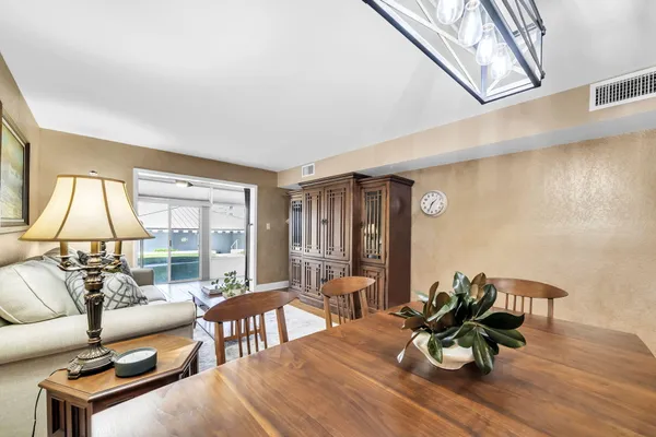 a living room with furniture a lamp next to a window
