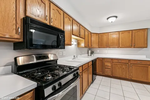 a kitchen with a stove a sink and a microwave