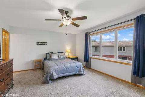 a bedroom with a bed and a large window