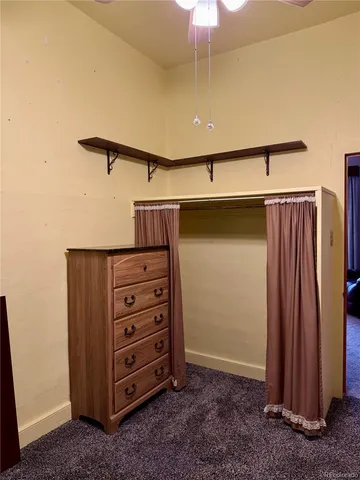 a kitchen with a refrigerator and a stove top oven