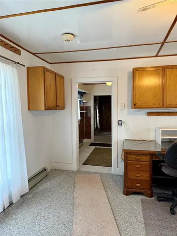 a living room with furniture and a ceiling fan