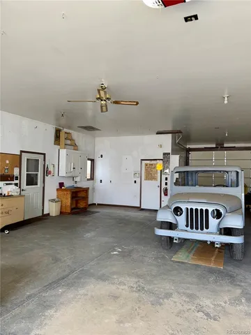 a view of a room with wooden floor and windows