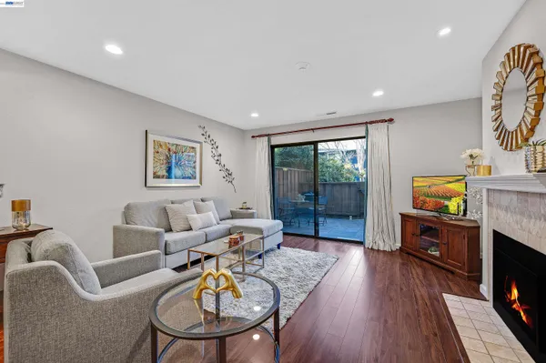 a living room with furniture a fireplace and a flat screen tv